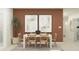 Dining room with white table, light wood chairs, and terracotta accent wall at 2732 Pioneer Trl, Eagle Lake, FL 33839