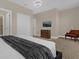 Bright bedroom with plush bed and tv at 305 Captiva Dr, Davenport, FL 33896