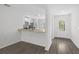 Kitchen and entryway with gray wood-look flooring at 310 Amberjack Ln, Poinciana, FL 34759