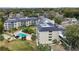 Aerial view showing building, pool, and surrounding area at 101 N Grandview St # 312, Mount Dora, FL 32757