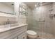 Bathroom with white vanity and tiled shower with modern fixtures at 101 N Grandview St # 312, Mount Dora, FL 32757