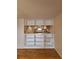 View of the kitchen area from the living room with open shelving at 101 N Grandview St # 312, Mount Dora, FL 32757