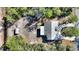 Overhead view of house, detached shed, and circular driveway at 3060 Granada Dr, Indian Lake Estates, FL 33855