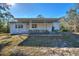 House with covered patio and lush landscaping at 3060 Granada Dr, Indian Lake Estates, FL 33855