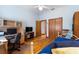 Bedroom with hardwood floors, a desk and twin bed at 3060 Granada Dr, Indian Lake Estates, FL 33855