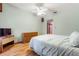 Bedroom with wood floors, dresser, and TV at 3060 Granada Dr, Indian Lake Estates, FL 33855