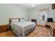 Spacious bedroom with wood flooring and dresser at 3060 Granada Dr, Indian Lake Estates, FL 33855