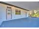 Covered patio with exterior door and window at 3060 Granada Dr, Indian Lake Estates, FL 33855