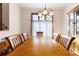 Bright dining room features a large wood table with seating for six and a lovely chandelier at 3060 Granada Dr, Indian Lake Estates, FL 33855