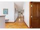 Light-filled hallway with hardwood floors and access to other rooms at 3060 Granada Dr, Indian Lake Estates, FL 33855