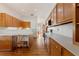 Kitchen with light wood cabinets and white countertops at 3060 Granada Dr, Indian Lake Estates, FL 33855