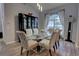 Elegant dining room with glass table, patterned chairs, and hardwood floors at 36320 Piney Ridge Blvd, Fruitland Park, FL 34731