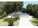 Single-story home with two-car garage, driveway, and mature landscaping at 36320 Piney Ridge Blvd, Fruitland Park, FL 34731