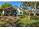 Backyard with patio, covered lanai, and lush landscaping at 7006 Arcadian Ct, Mount Dora, FL 32757