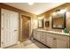 Elegant bathroom with double vanity, granite countertops, and a walk-in shower at 7006 Arcadian Ct, Mount Dora, FL 32757