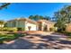 House with paved driveway and landscaped front yard at 7006 Arcadian Ct, Mount Dora, FL 32757