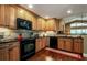 Updated kitchen featuring black appliances and light wood cabinetry at 7006 Arcadian Ct, Mount Dora, FL 32757