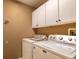 Laundry room with white cabinets, Maytag washer and dryer, and overhead storage at 7006 Arcadian Ct, Mount Dora, FL 32757