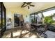 Screened porch with a dining set and sliding glass doors leading inside at 7006 Arcadian Ct, Mount Dora, FL 32757