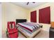 Bedroom with carpeted floors, a window, and a striped bedspread at 422 W Division St, Clermont, FL 34715
