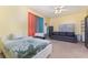 Bedroom featuring a ceiling fan, plush carpet, a large window, and a comfortable sofa at 422 W Division St, Clermont, FL 34715