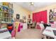 Bright bedroom with a ceiling fan, plush carpet, and a large window at 422 W Division St, Clermont, FL 34715