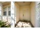 Covered entryway featuring the front door and sidelight windows with natural light at 422 W Division St, Clermont, FL 34715