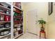 Hallway featuring tiled floors, a storage shelf and a neutral-colored door at 422 W Division St, Clermont, FL 34715