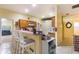 Eat-in kitchen featuring a breakfast bar, ample counter space, and tiled floors at 422 W Division St, Clermont, FL 34715