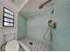 Bathroom with light green tile shower and patterned floor at 6821 Rembrandt Dr, Orlando, FL 32818