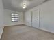 Spacious bedroom with window and neutral carpeting at 6821 Rembrandt Dr, Orlando, FL 32818