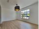 Bright dining room featuring light wood floors and a large window at 6821 Rembrandt Dr, Orlando, FL 32818