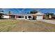Brick ranch house with a white front door, attached garage, and well-manicured lawn at 6821 Rembrandt Dr, Orlando, FL 32818