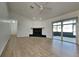 Spacious living room with wood floors, fireplace, and sliding glass doors at 6821 Rembrandt Dr, Orlando, FL 32818