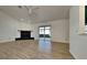 Living room with wood floors, fireplace and sliding glass doors leading to patio at 6821 Rembrandt Dr, Orlando, FL 32818