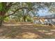 Spacious backyard with large shade tree and detached shed at 820 Lakeshore Dr, Lakeland, FL 33801