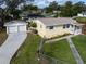 2-car garage, walkway to a yellow ranch house at 228 Azalea St, Lakeland, FL 33803