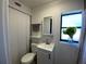 Clean bathroom featuring a shower/tub combo, vanity, and window at 228 Azalea St, Lakeland, FL 33803