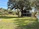 Spacious backyard with grassy area and mature trees at 2541 E Lake Dr, Deland, FL 32724
