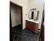 Stylish bathroom with double vanity, hexagon tile floors and modern fixtures at 2541 E Lake Dr, Deland, FL 32724