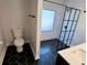 Updated bathroom features a walk-in shower, hexagon tile floor and a toilet at 2541 E Lake Dr, Deland, FL 32724