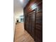 Hallway with wood wall and louvered doors at 2541 E Lake Dr, Deland, FL 32724