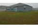 Expansive backyard with green grass and a sliding glass door at 400 Watusi Way, St Cloud, FL 34772