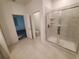 Bathroom with a walk-in shower with clear glass doors and a door that leads to the bedroom at 400 Watusi Way, St Cloud, FL 34772