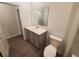 Modern bathroom with gray vanity and a large mirror at 400 Watusi Way, St Cloud, FL 34772