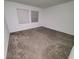 Bedroom with neutral carpet, white walls, and two windows for natural light at 400 Watusi Way, St Cloud, FL 34772