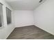 Bright bedroom with two windows and gray floor tiles at 400 Watusi Way, St Cloud, FL 34772