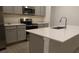 Quartz countertops and stainless steel appliances highlight this modern kitchen at 400 Watusi Way, St Cloud, FL 34772