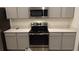The kitchen features stainless steel appliances, gray cabinets, and quartz countertops at 400 Watusi Way, St Cloud, FL 34772