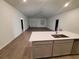 Open concept floor plan with a view from the kitchen island into the large living room at 400 Watusi Way, St Cloud, FL 34772